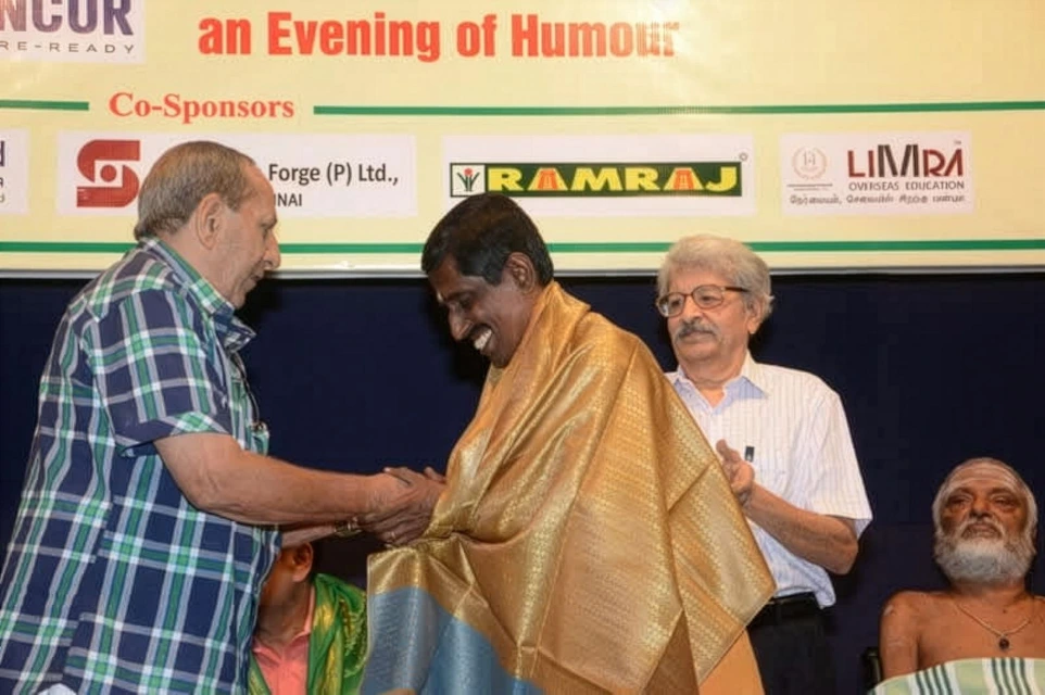 "Sirippoli Chidambaram receiving recognition on stage"